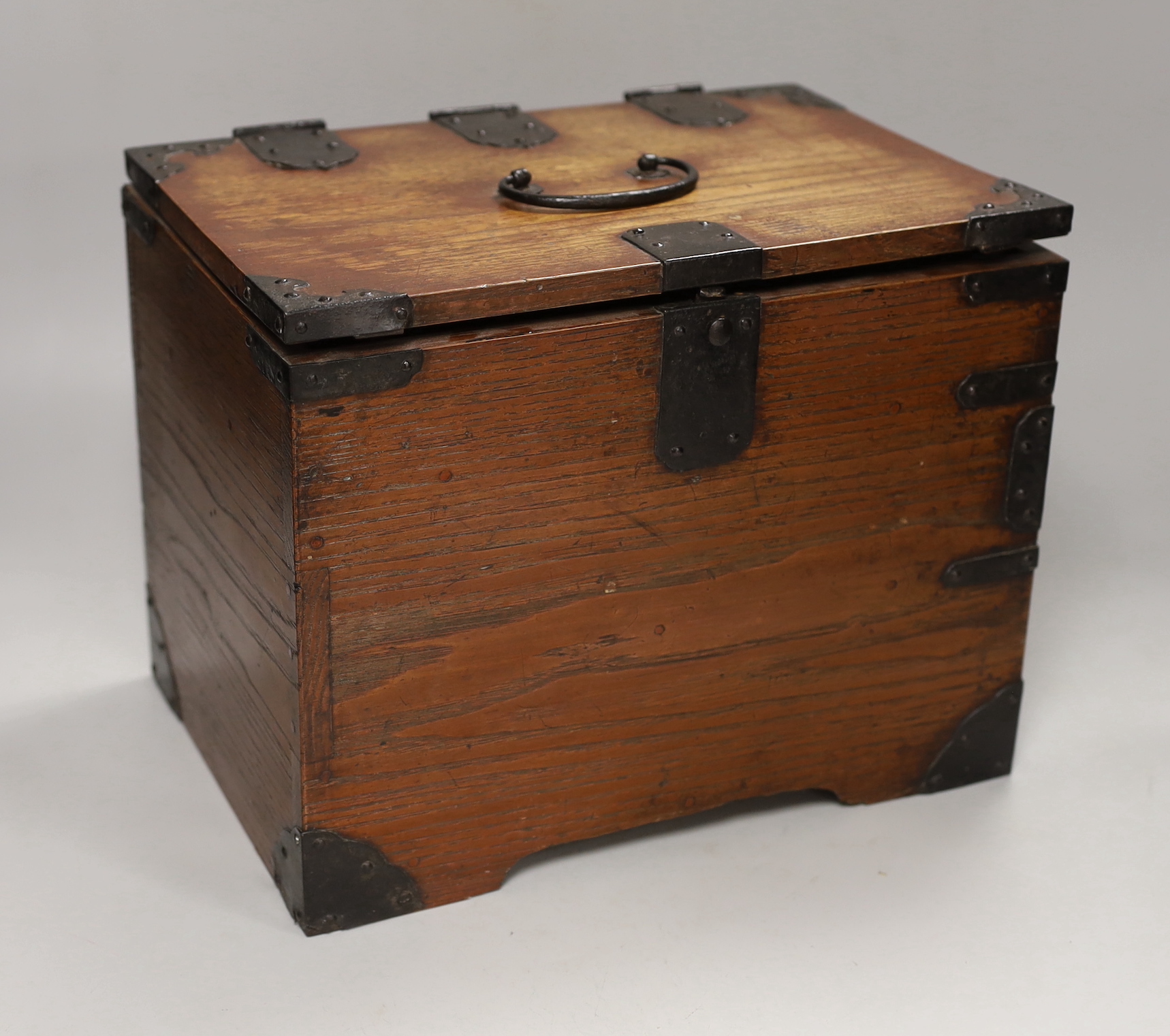 A Japanese iron mounted box, with black lacquer interior tray, box 30cm wide